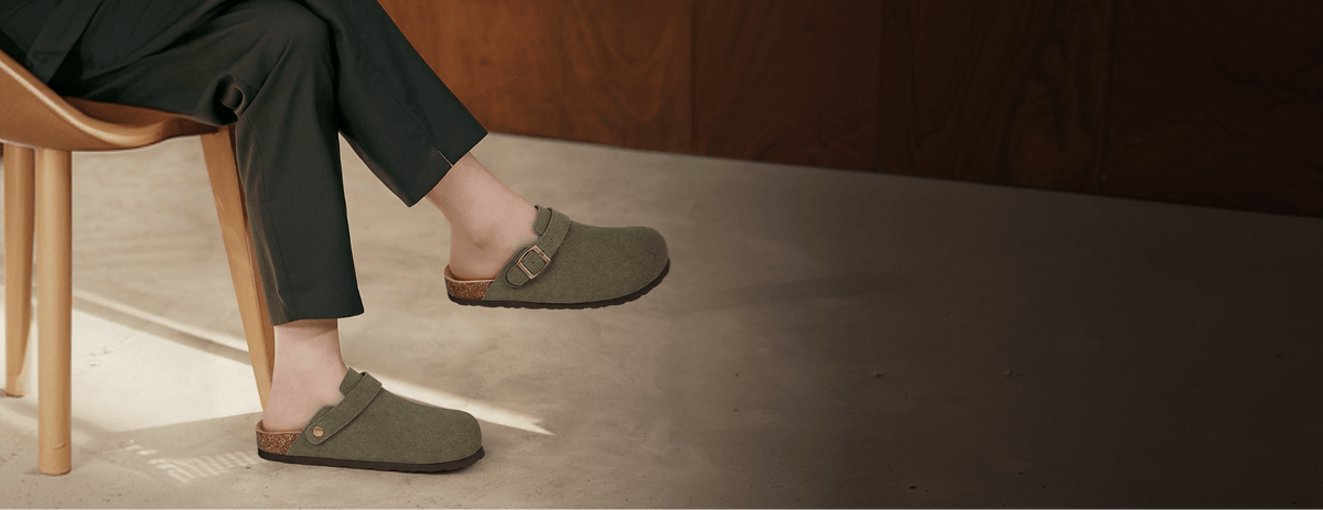 Olive felt clogs worn with tailored trousers